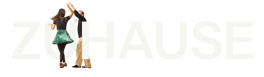 Paar tanzt Tango vor schwarzem Hintergrund mit großem weißem Schriftzug Zuhause